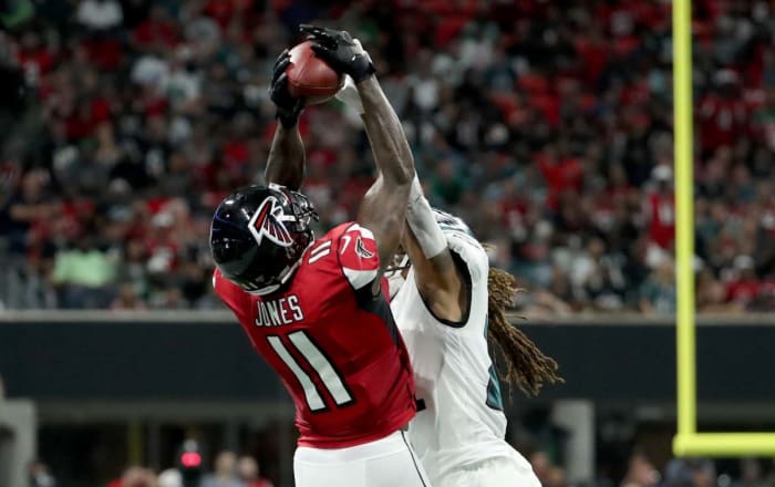 atlanta Falcons wide receiver Julio Jones reaches up to catch a pass as Philadelphia Eagles cornerback Ronald Darby reaches up to try to block it